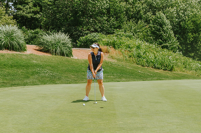 a woman golfing