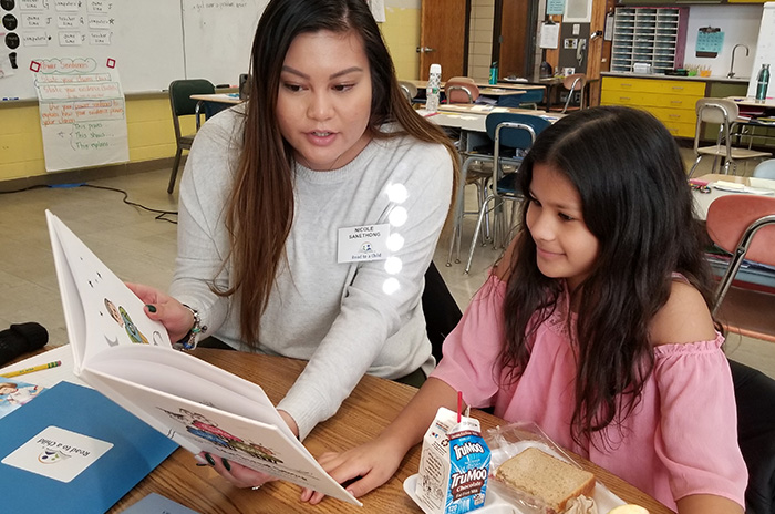 Teacher reading to a student