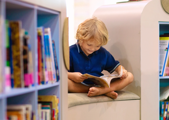 Boy sitting and reading a book