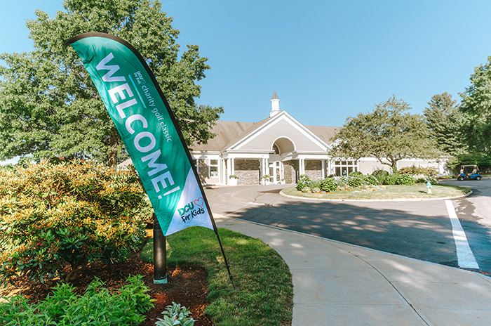 building with a vertical flag that says Welcome