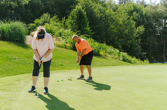 two people playing golf