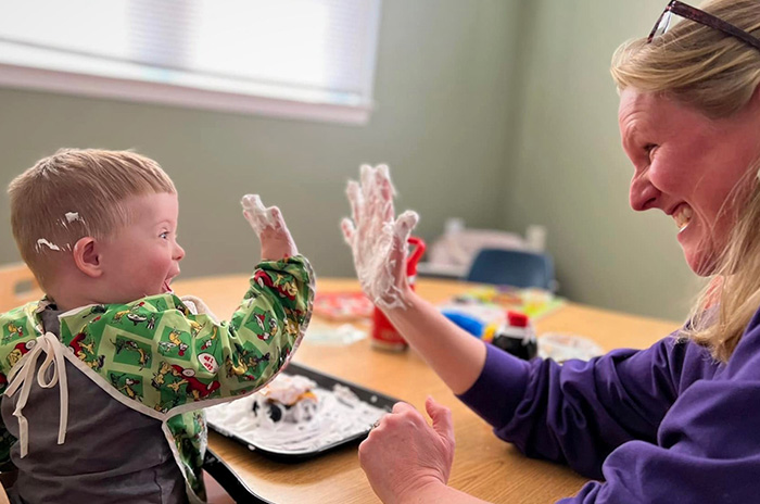 Small child and teacher doing a high five